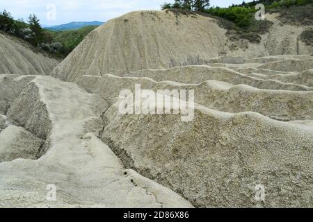 Landscape with cracked soil from Mud Volcanoes, at Paclele Mari, Romania. Volcanic rocks and lava of mud volcanoes. Lunar landscape in Europe Stock Photo