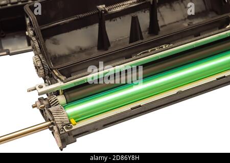 a worn disassembled printer cartridge with gears and a photoreceptor isolated on a white empty background Stock Photo