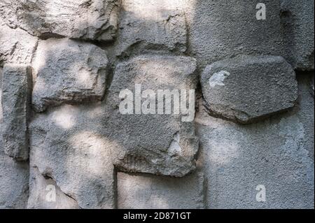 Background of the wall of big granite textured stones cemented together, horizontal view Stock Photo