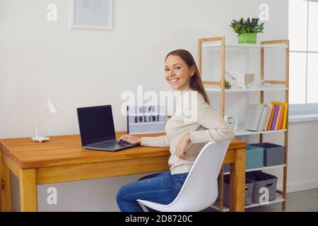 Cheerful woman working in modern home office Stock Photo