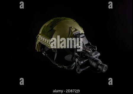 Night vision device attached to the helmet. A special device for observing in the dark. Equipment for the military, police and special forces. Stock Photo