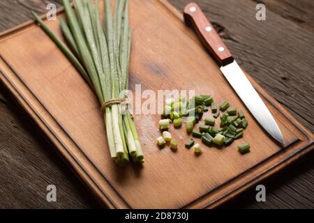 scallions, onion bulbs, wooden cutting, wooden board, old wooden, spring onions Stock Photo