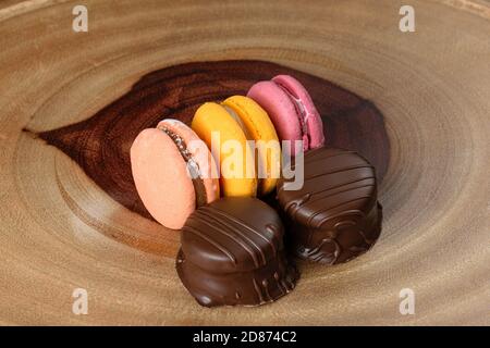 Brazilian honey cakes in the foreground and colorful macaroons in the background. Stock Photo