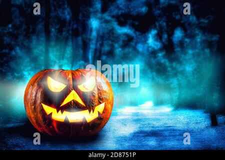The evil glowing eyes of Jack O' Lanterns through mist and fog in a ...