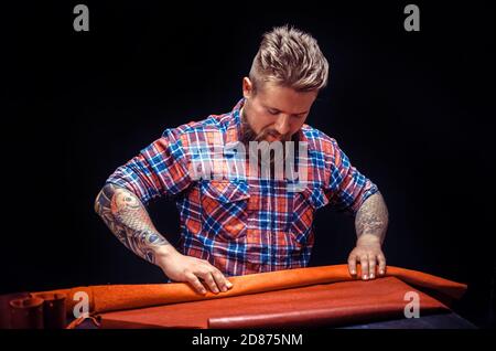 Leather Artisan making quality products in his studio Stock Photo