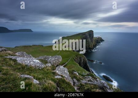 Dark and moody storm clouds over Neist Point lighthouse on the Isle of Skye. Stock Photo