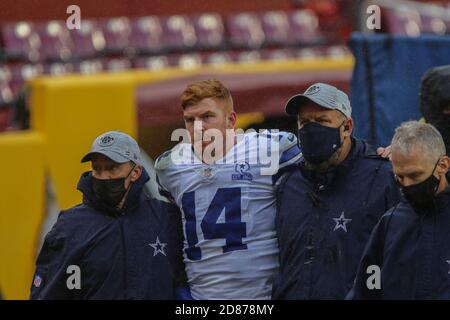 Landover, United States. 25th Oct, 2020. Dallas Cowboys quarterback Andy  Dalton (14) evades Washington Football Team linebacker Cole Holcomb (55)  during the first half of an NFL football game at FedEx Field