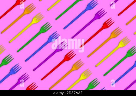 Multicolored plastic forks on a pink background. Creative minimal style Stock Photo