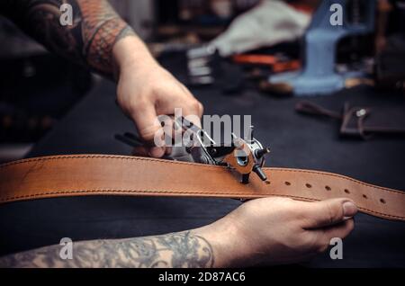 Leather cutter keen on one's business in the studio Stock Photo