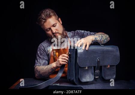 Leather Currier demostrating leather cutting process Stock Photo