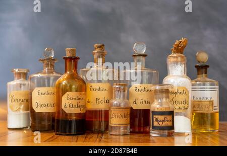 closeup of ancient apothecary pots with ingredients for medicine isolated over dark background