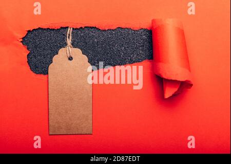 Gift Tag on red torn paper Stock Photo