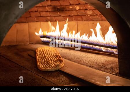 Traditional turkish wood fired stone brick oven and pita or pide bread  dough. This stone oven for Turkish pide or pita bread. Also known as Tandir  Stock Photo - Alamy