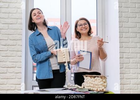 Interior design, working women designers choosing samples of fabrics Stock Photo