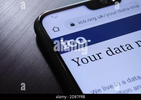 The Information Commissioner's Office ICO website seen on the smartphone corner. The United kingdom watc Stock Photo