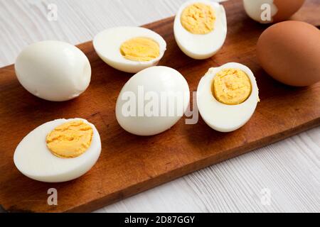 Hard Boiled Eggs on a rustic wooden board, low angle view. Close-up. Stock Photo