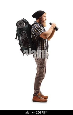 Full length profile shot of a bearded man hiker looking with binoculars isolated on white background Stock Photo