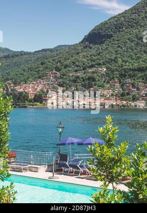 summer holidays in a renowned tourist resort. swimming pool overlooking the Como lake. summer season in Lombardy. italy Stock Photo