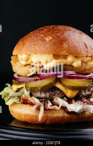 American craft juicy burger on black background Stock Photo
