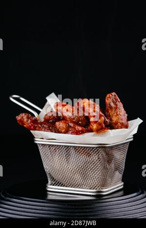 BBQ chicken wings on black background Stock Photo