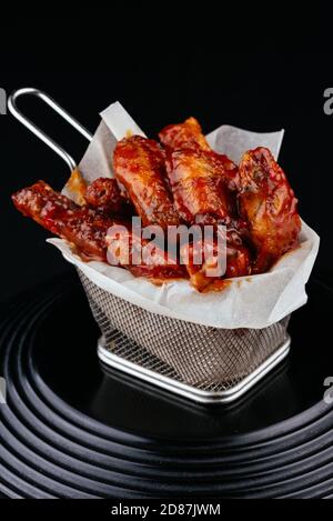 BBQ chicken wings on black background Stock Photo