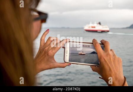 Ship MS Kong Harald, mobile phone photography, ship filming, Bolga, Nordland, Norway, Scandinavia, Europe, adventure travel, tourism, Hurtigruten, Hur Stock Photo