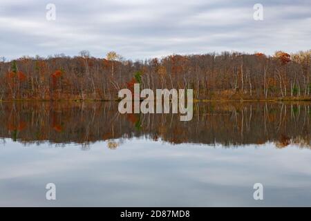 Shore reflection on lake in the fall Stock Photo