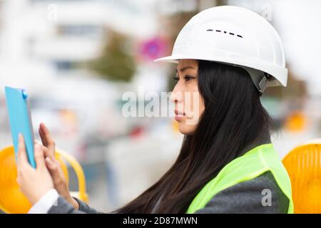 woman leader standing outside with helmet Stock Photo