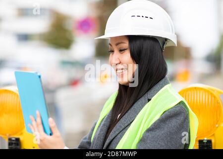 woman leader standing outside with helmet Stock Photo