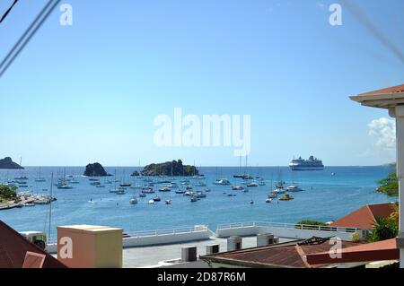 Bay area with boats and Celebrity summit cruise ship in Gustavia,St barth.Clear blue sky and calm ocean water. Stock Photo