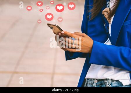 Woman holding smartphone. Social media illustration.Liking, chatting, commenting Stock Photo