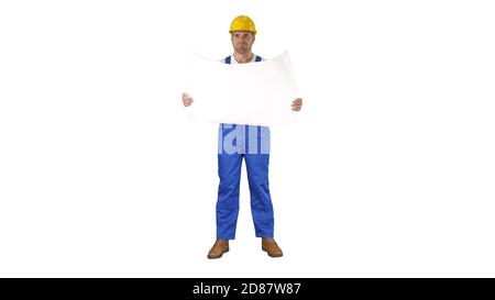 Construction worker checking blueprints on site on white background. Stock Photo