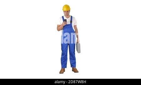 Factory worker employee chatting browsing texting on smartphone on white background. Stock Photo