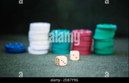 Casino poker chips stack dice on green felt background Stock Photo