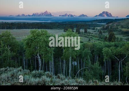 Grand Teton and the Teton Range with low clouds before sunrise in Grand Teton National Park in Wyoming, USA. Stock Photo