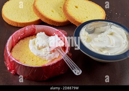 Cake assembly. layer cake with white icing. Stock Photo