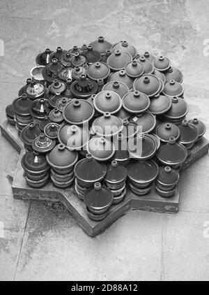 Dozens of tagine earthenware pots are piled high for display in Morocco. Stock Photo