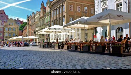 Outdoor cafes line the Old Town Square in Poznan, Poland during the summer. Stock Photo