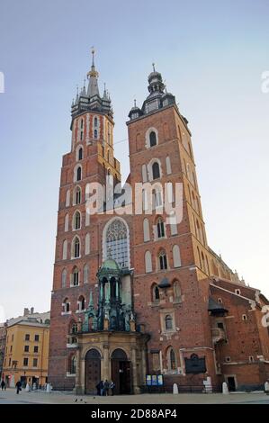 The iconic and historic St. Mary's Basilica in Krakow, Poland, is a Roman Catholic church built in the Polish Gothic Architectural style. Stock Photo