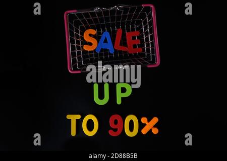 Black friday concept. Sale up to 90 per cent. Shopping basket at black Stock Photo