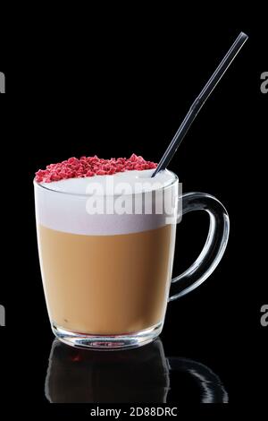 Cappuccino with strawberry topping in transparent cup isolated on black background
