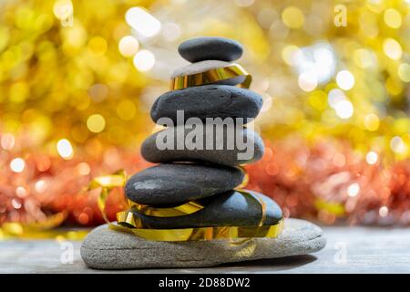 Christmas tree made of pebble stones on a background of beautiful bokeh. Stock Photo