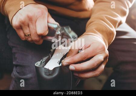 Shoemaker making shoe using shoemaker tools Stock Photo