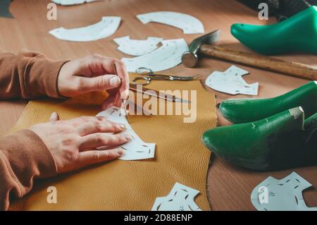 Close up of shoemaker at work on the table Stock Photo