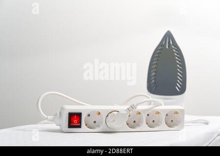powered Iron in extension cord with copy space. electrical extension cord with overload protection. Stock Photo