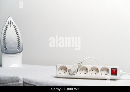 powered Iron in extension cord with copy space. electrical extension cord with overload protection. Stock Photo