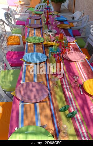 Table set for meals around the pool Stock Photo