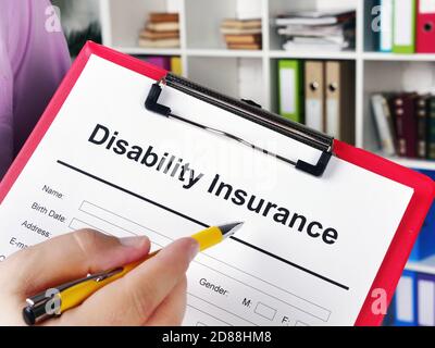 Insurer shows Disability insurance application for signing. Stock Photo