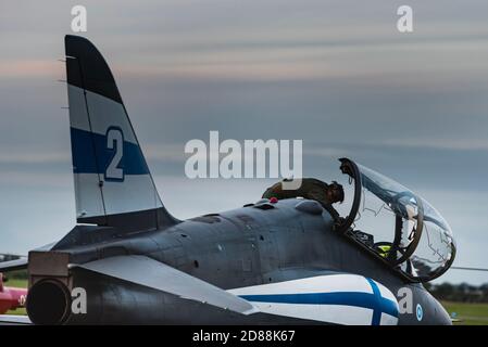 A pilot prepares his Finnish fighter plane before taking off. Finnish Hawk jet Fighter checked by a pilot provides an Air Force Academy illustration Stock Photo