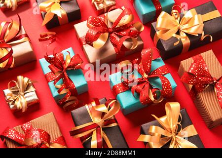 Festively wrapped gift boxes on red background. Isometric view. Holiday concept Stock Photo